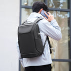 Man in light gray coat wearing MarkRyden Eminence stylish black leather waterproof backpack with USB port