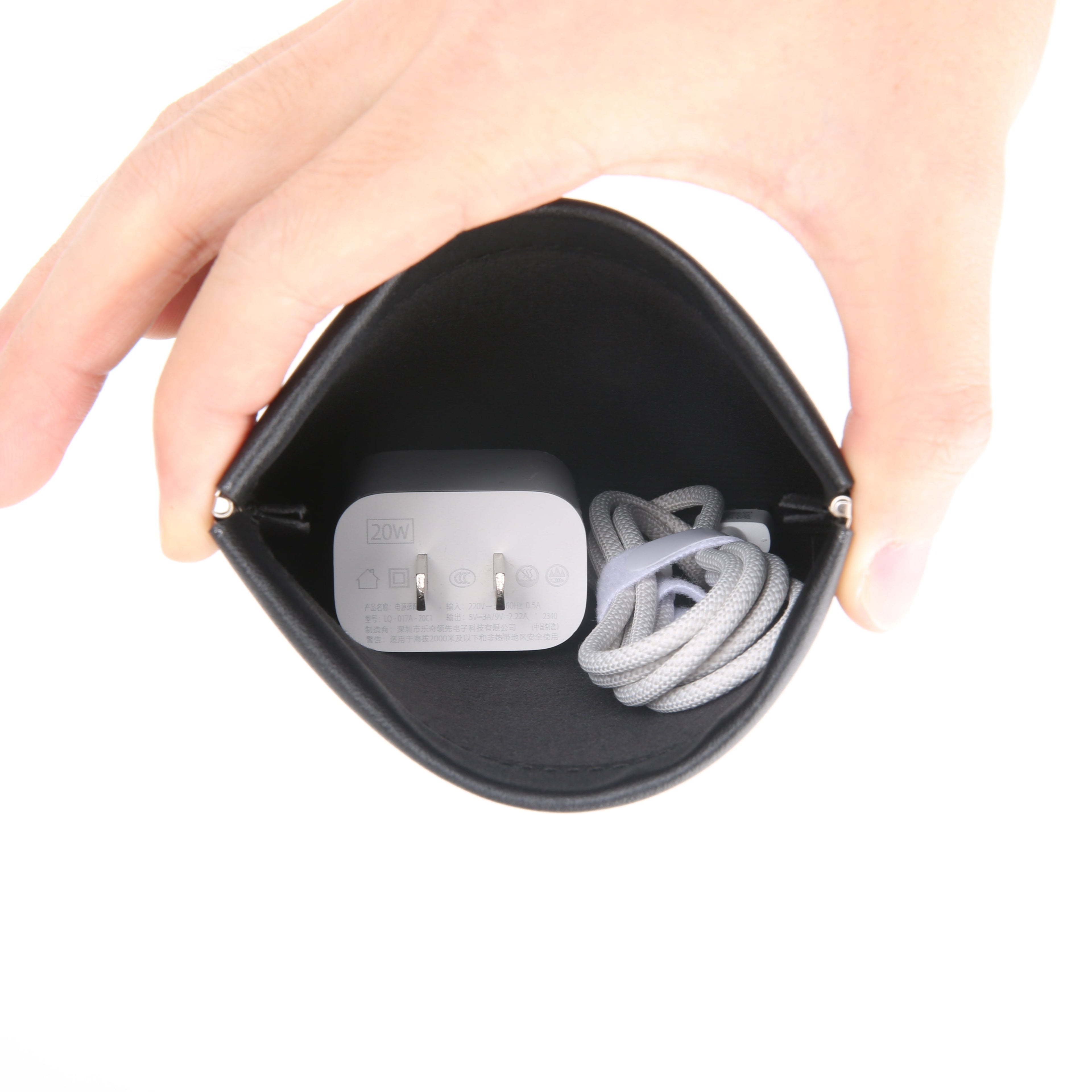 Markryden black anti-theft coin pouch held open, holding 20W charger and cable