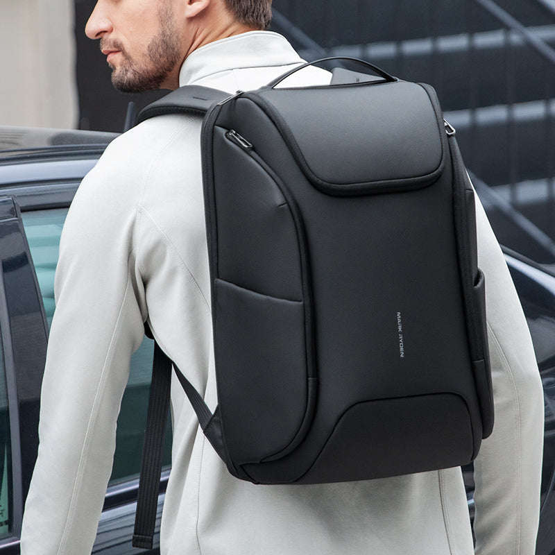 Black waterproof MARKRYDEN backpack with built-in USB port, designed for modern travelers.