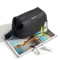 MarkRyden black toiletry bag with wet dry sections on travel magazines