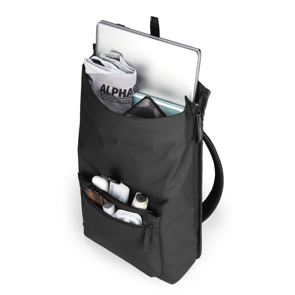 Trendy black leather casual multilayer storage backpack with front zip pocket holding small items and main compartment containing laptop, books, and a gym bag.