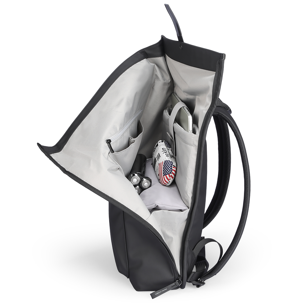 Trendy black leather casual backpack with multilayer storage, open to display gray interior compartments holding laptop, small flag-patterned bag, and accessories.