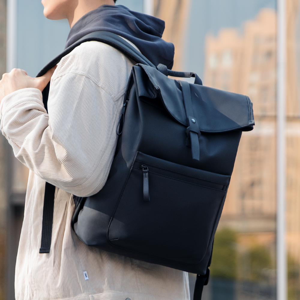 Trendy black leather casual backpack with multilayer storage, flap closure, and front zip pocket for modern travelers.