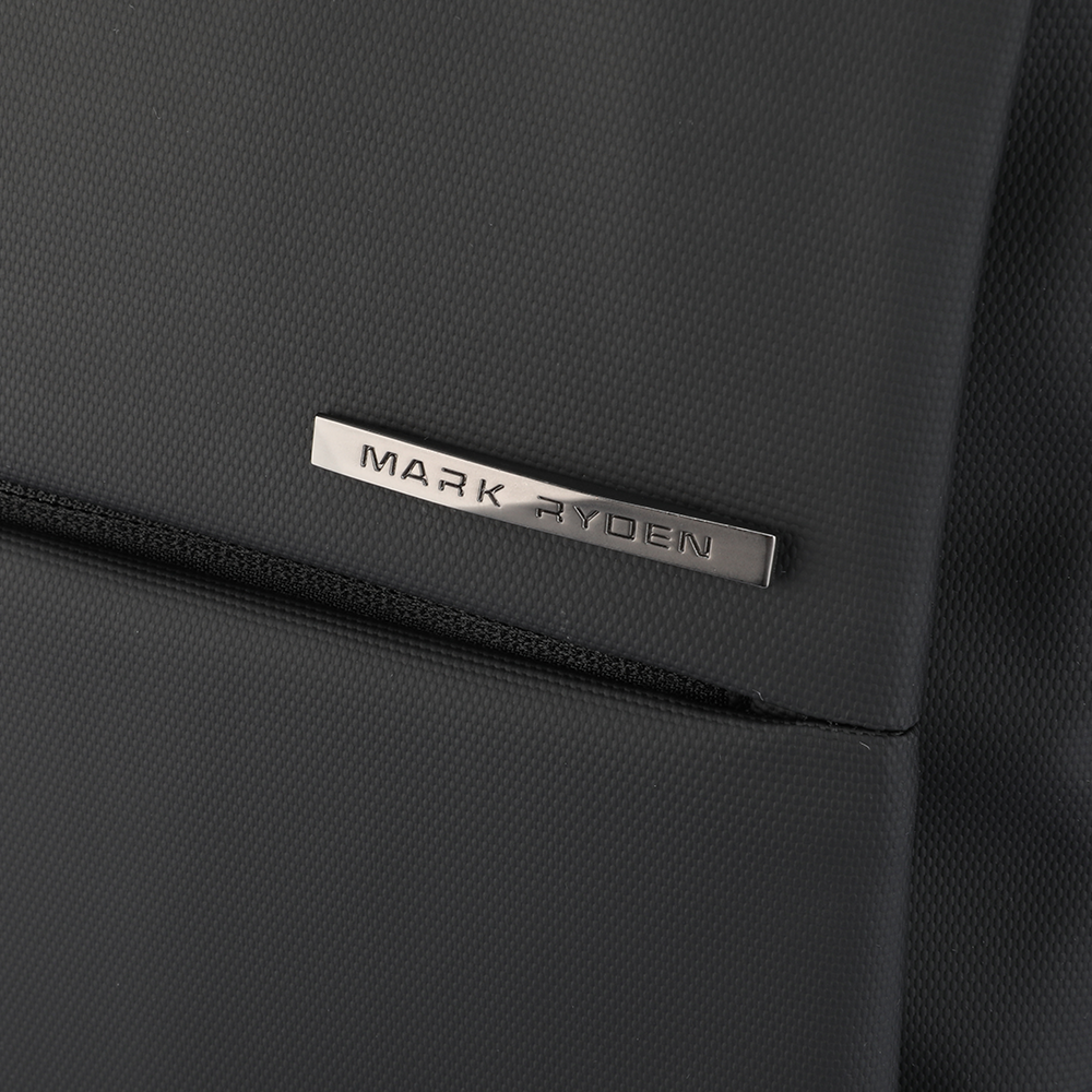 Close-up of black textured fabric on Mark Ryden UNBURDENED LIGHT Business Multi-Layers 15.6 Inch Laptop Backpack with metallic brand plate.
