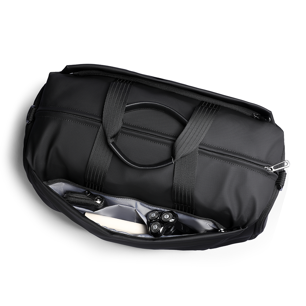 Black leather multifunctional fitness sports handheld crossbody bag with open compartment revealing gray lining and items like a razor.