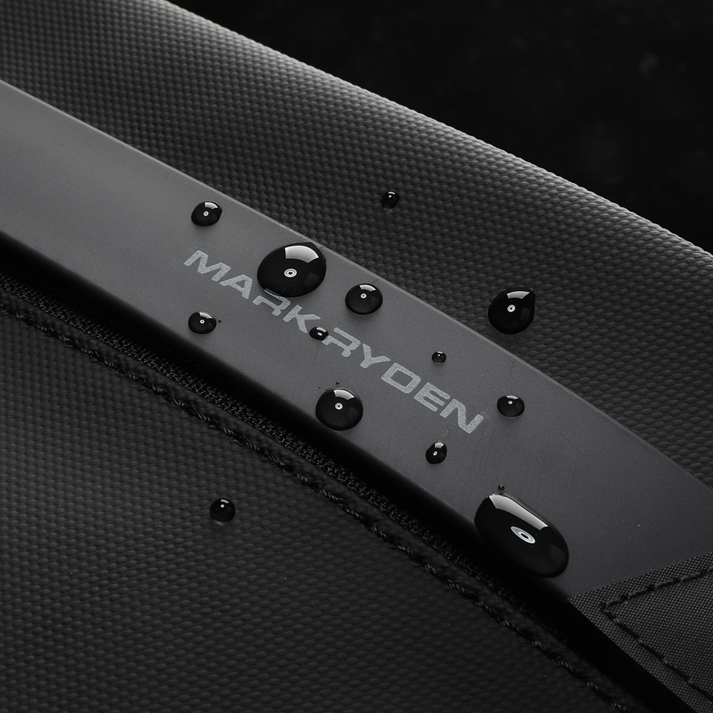 MarkRyden waterproof crossbody bag with water droplets showing durability