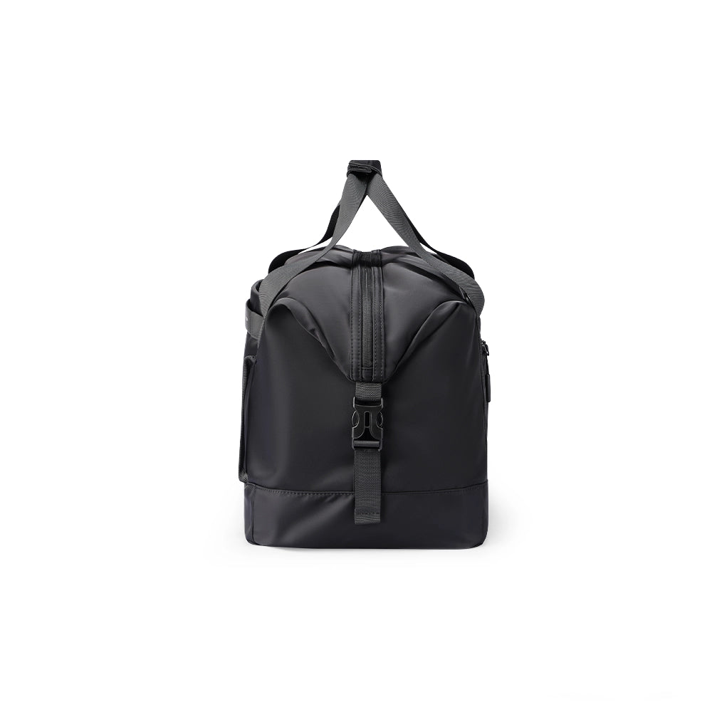 Black NomadFlex 3-in-1 waterproof gym bag with gray straps, front zipper, and buckle, designed for fitness enthusiasts.