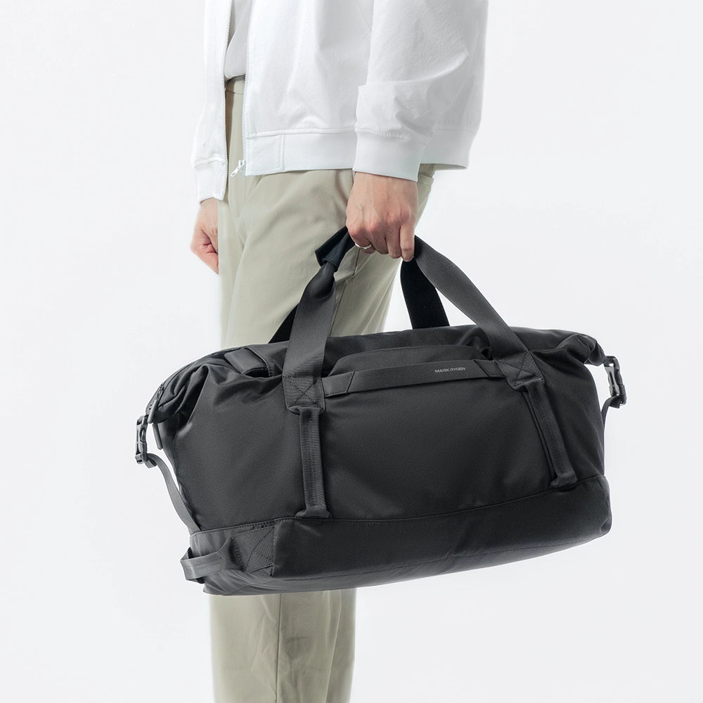 MarkRyden NomadFlex 3-in-1 waterproof gym bag black, held by person