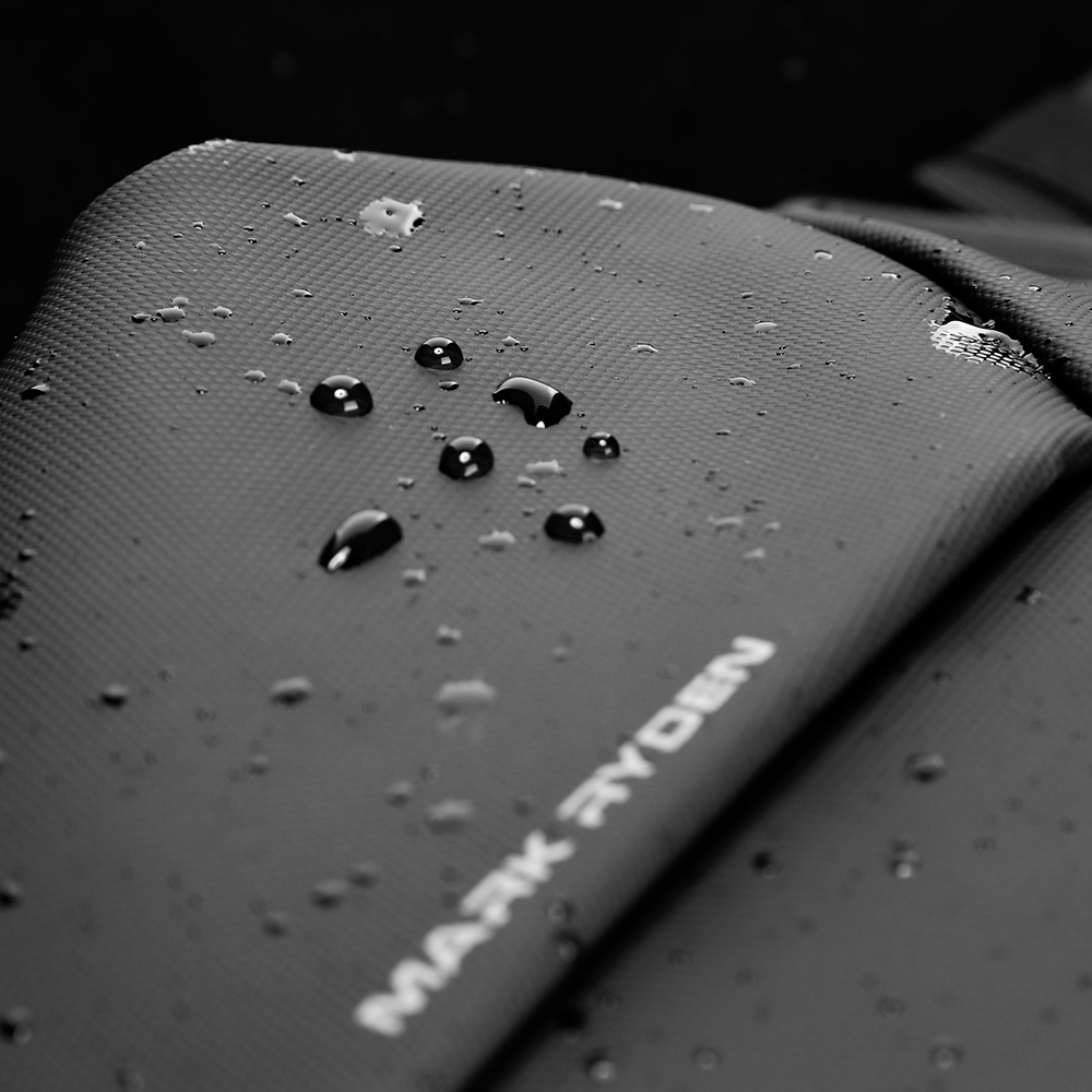 MarkRyden MetroFlex waterproof crossbody bag with water droplets on textured material