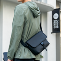 MarkRyden sleek black crossbody bag on model in business casual travel style