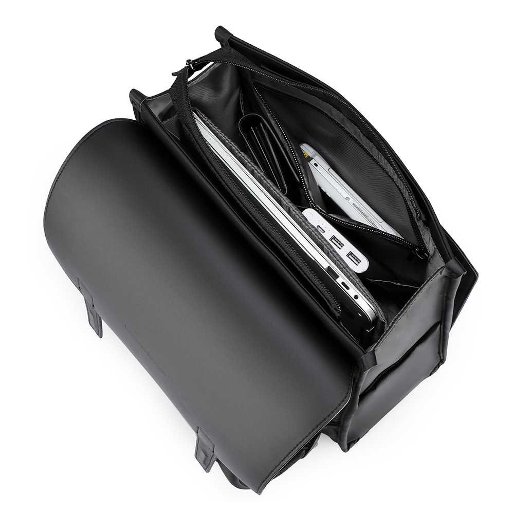 Black MUKE III Oxford backpack with open main compartment storing a laptop and other devices, ideal for school and business work.