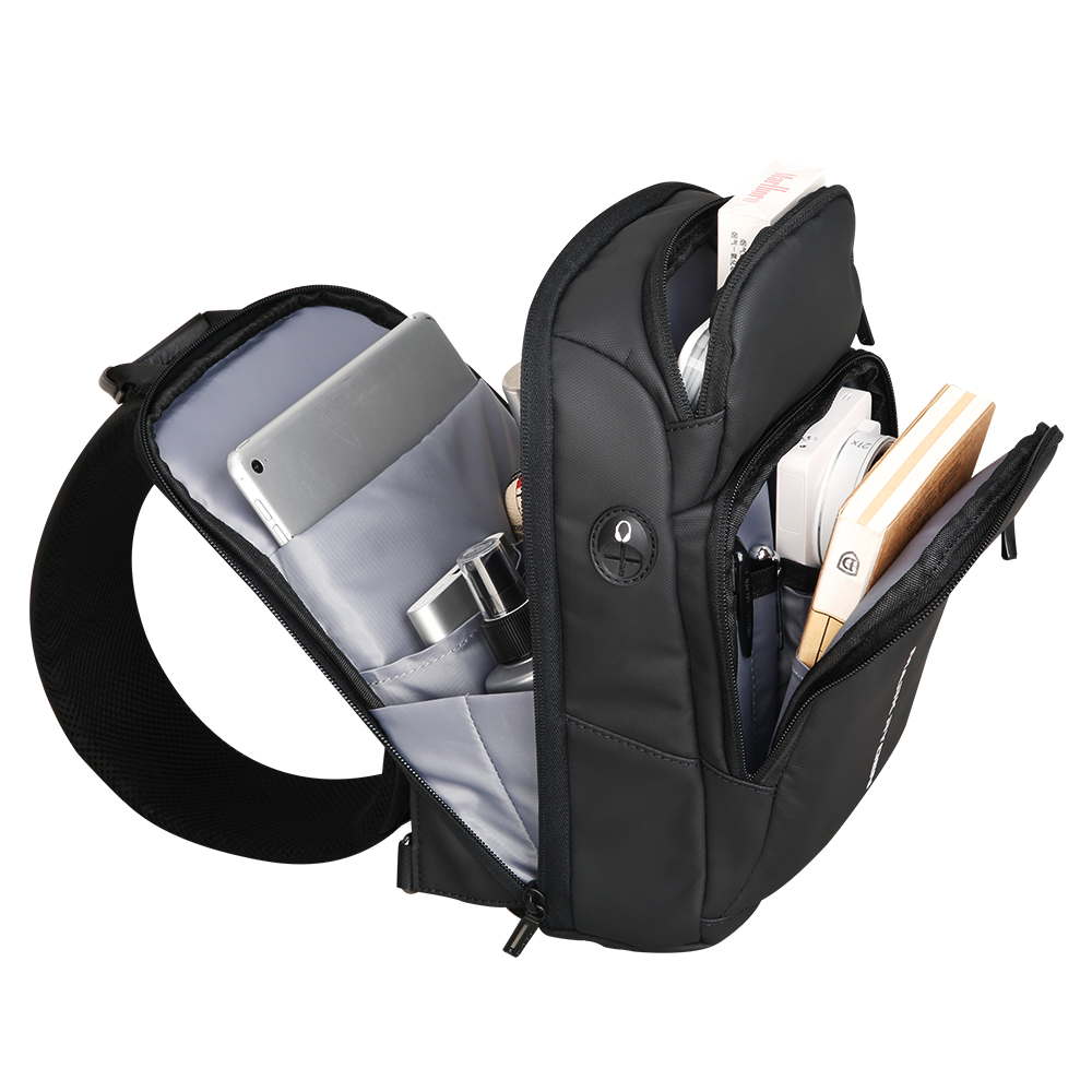 MarkRyden black minimalist tablet sling bag with multi-layer compartments holding tablet & accessories