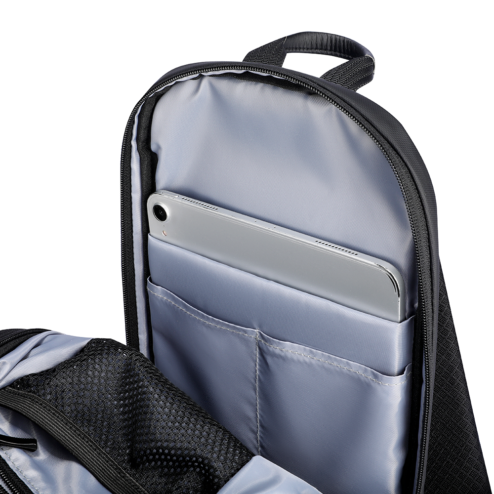 MarkRyden Colonne High-capacity Urban Commuting Crossbody Bag interior with gray lining, tablet pocket holding silver tablet, black exterior.