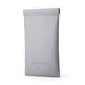 Light gray faux leather sunglasses pouch with roll-top closure, designed to carry eyeglasses or data cables by MARK RYDEN.