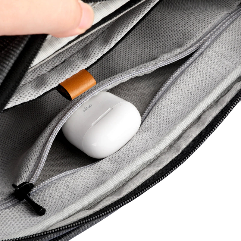 Fingon Ⅰ leather large capacity commuter bag interior with zip pocket holding white AirPods case