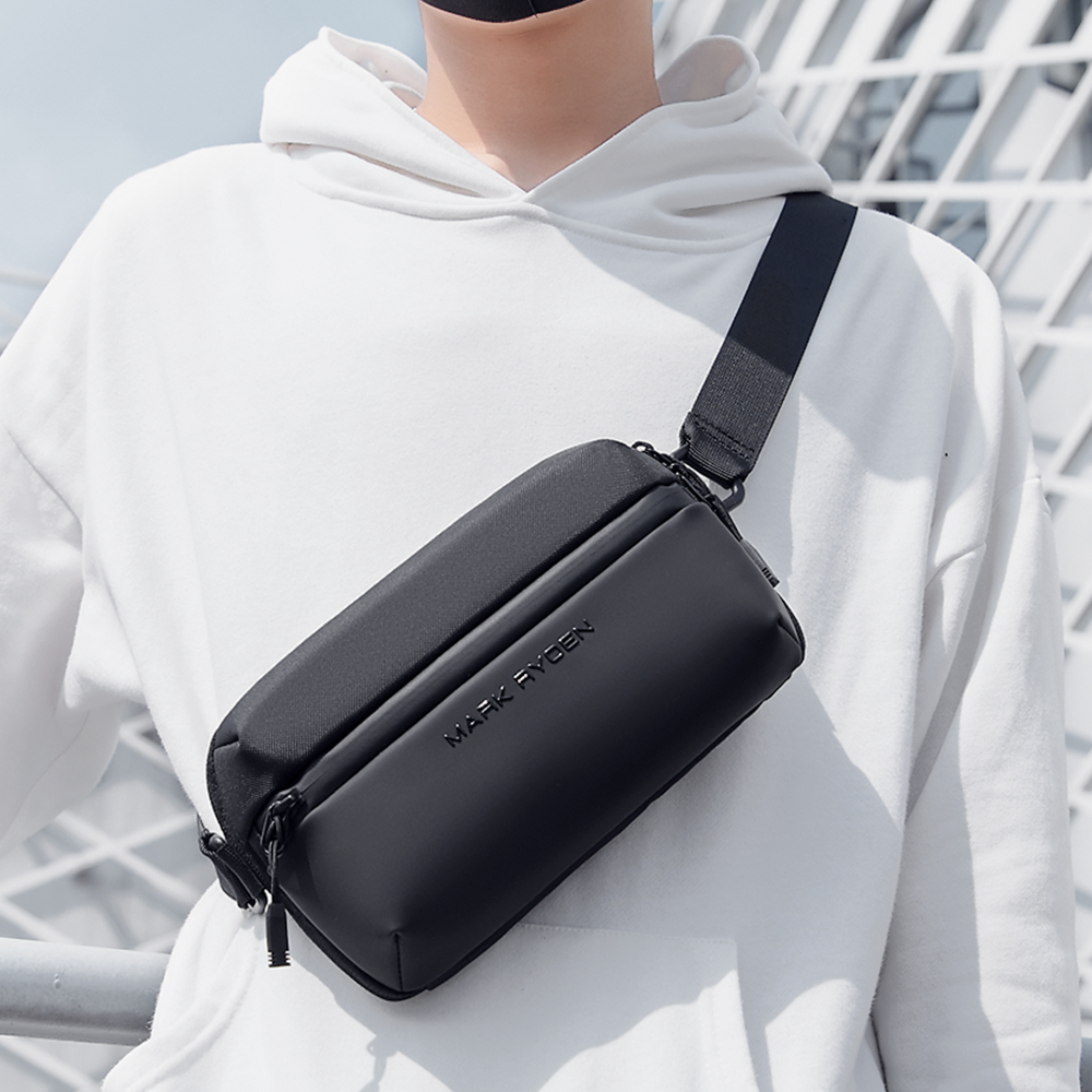 Mark Ryden Fingon III black waterproof crossbody bag on model in white hoodie