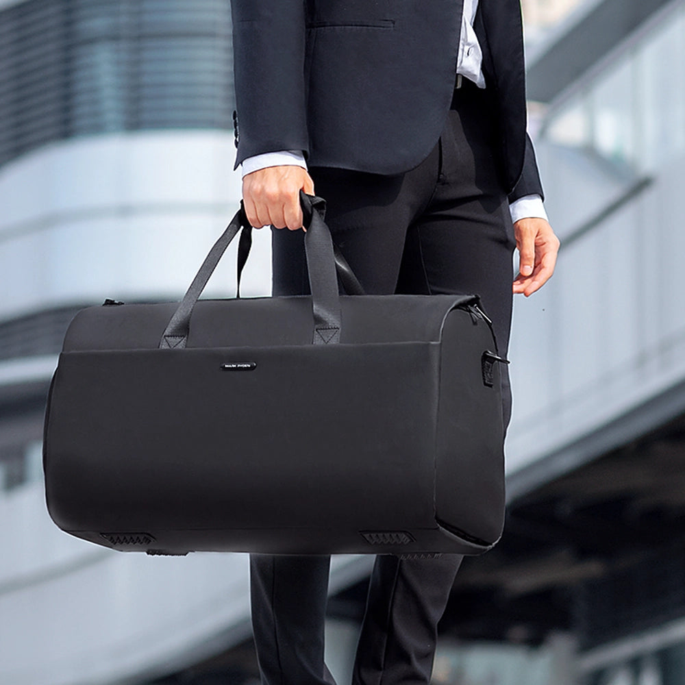 Markryden black water-resistant business travel bag held by businessman in suit