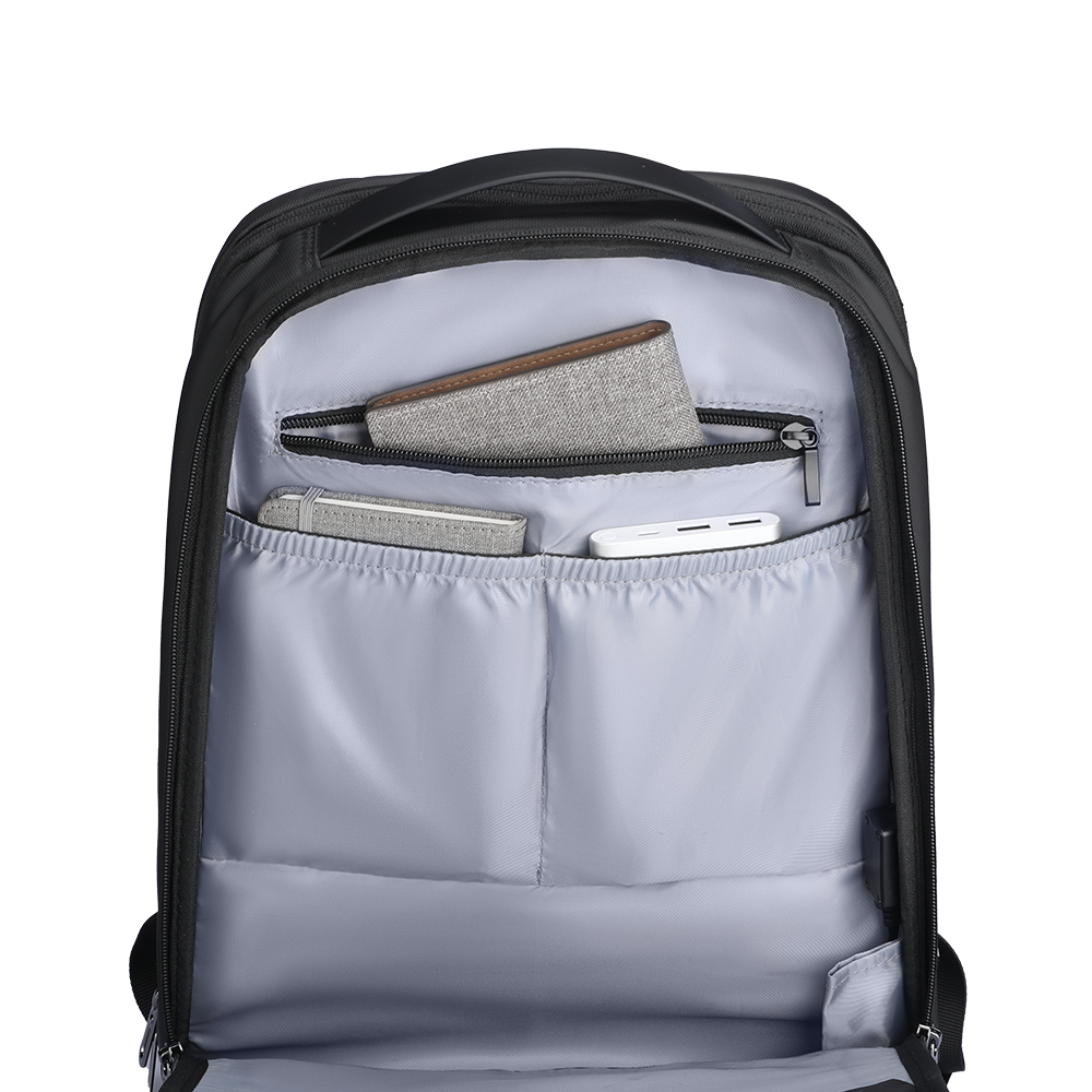 Black futuristic design minimalist lightweight backpack interior with light gray lining, multiple compartments holding wallet, notebook, and power bank.