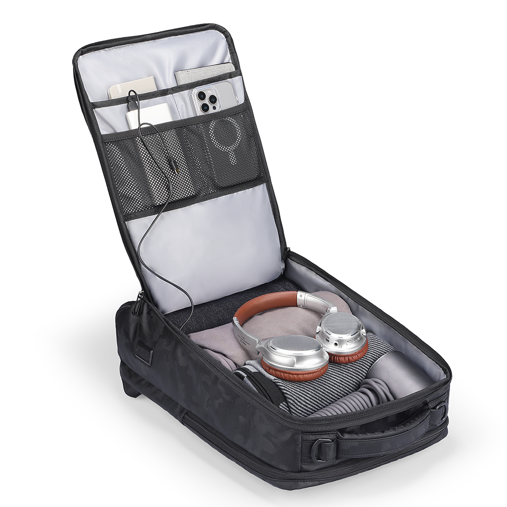 MarkRyden Compacto Pro I 30L tactical commuter backpack with organized interior featuring headphones, clothing, and tech accessories