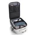 White Urbanity City Commuter Oxford USB Port 17.3 inch Laptop Backpack open, displaying organized interior with mesh pockets, rolled blue jeans, gray clothing, and umbrella.