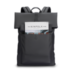 Minimalism Ⅰ dark gray roll-top backpack with front pocket holding Kinfolk Home magazine, designed for daily commute