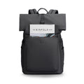 MARKRYDEN black minimalist backpack with front pocket holding Kinfolk magazine - daily commuter bag