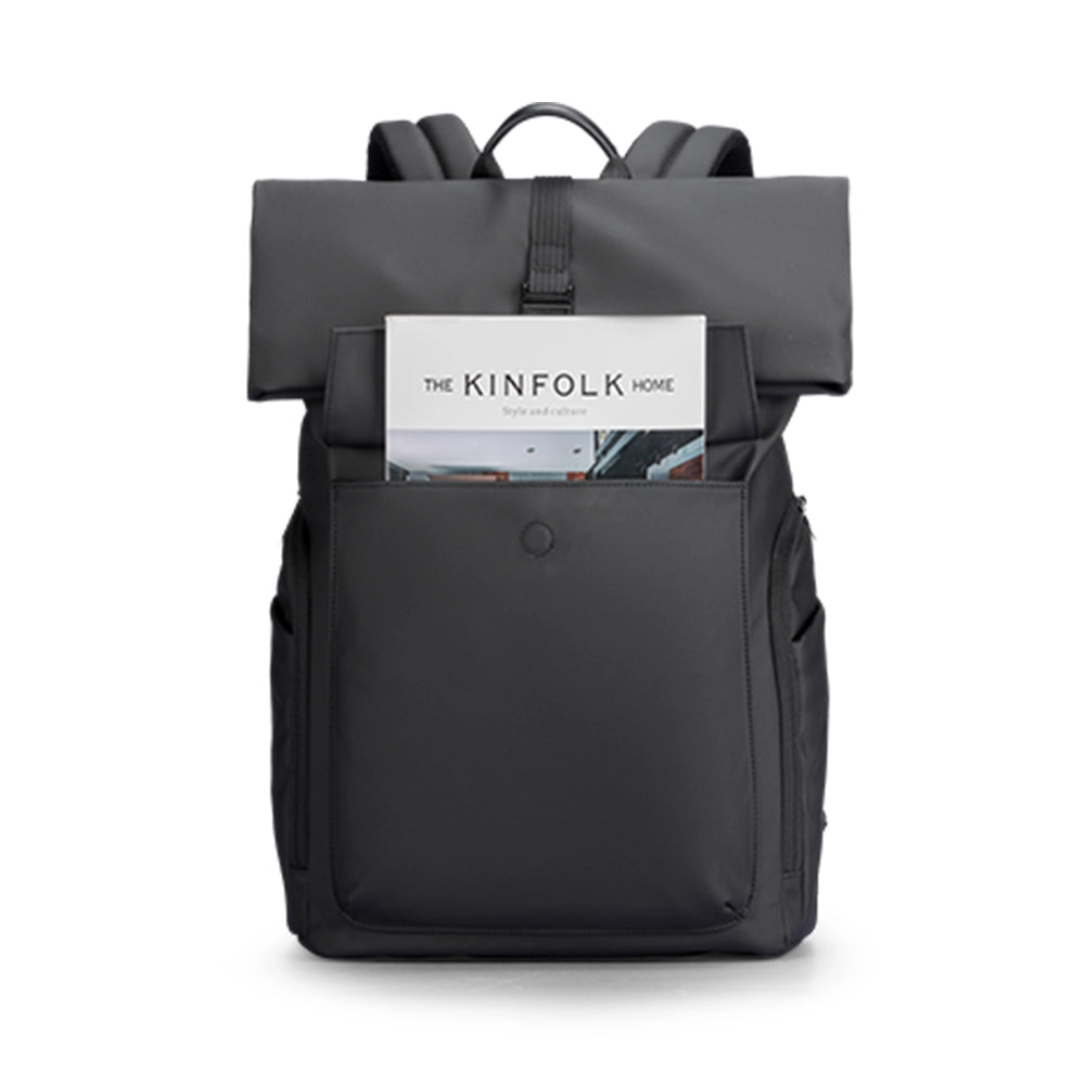 MARKRYDEN black minimalist backpack with front pocket holding Kinfolk magazine - daily commuter bag