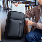 Mark Ryden logo on black expandable backpack holding laptop