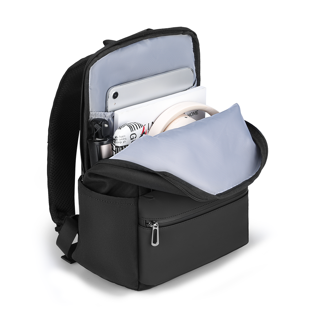 Black water-repellent backpack with open compartments holding tablet, smartphone, documents, water bottle, and cushion—perfectly sized organized companion for essentials.