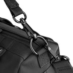 Black MotoBarrel cylinder crossbody bag with adjustable strap and metal hardware