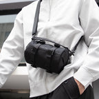 MarkRyden black cylinder crossbody bag with strap, fashion-forward design